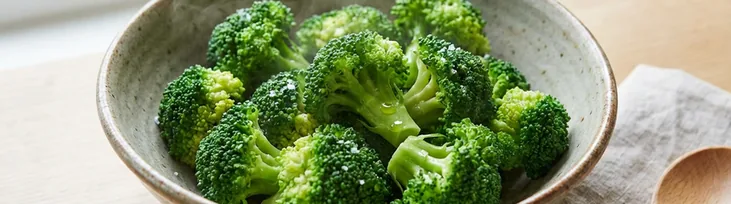 Fresh green broccoli florets on white background